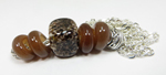 Allspice around a focal cube bead of Effetre White with Glass Diversions Coffee Bean frit