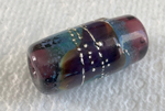 A barrel bead made with a base of CiM's Aiko Ltd Run in the centre and CiM Emperor ends.