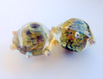 Messy Truffle as a base for fine granulated frit, encased using Effetre Super Clear and decorated with Double Helix silver glass