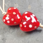 Solid Firecracker heart shaped beads with dots of striking Effetre tongue pink.