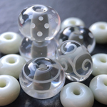 These beads are Bayou with a thick encasing layer of Effetre Super (Crystal) Clear 006 and the decoration and spacers are Peppermint Cream.